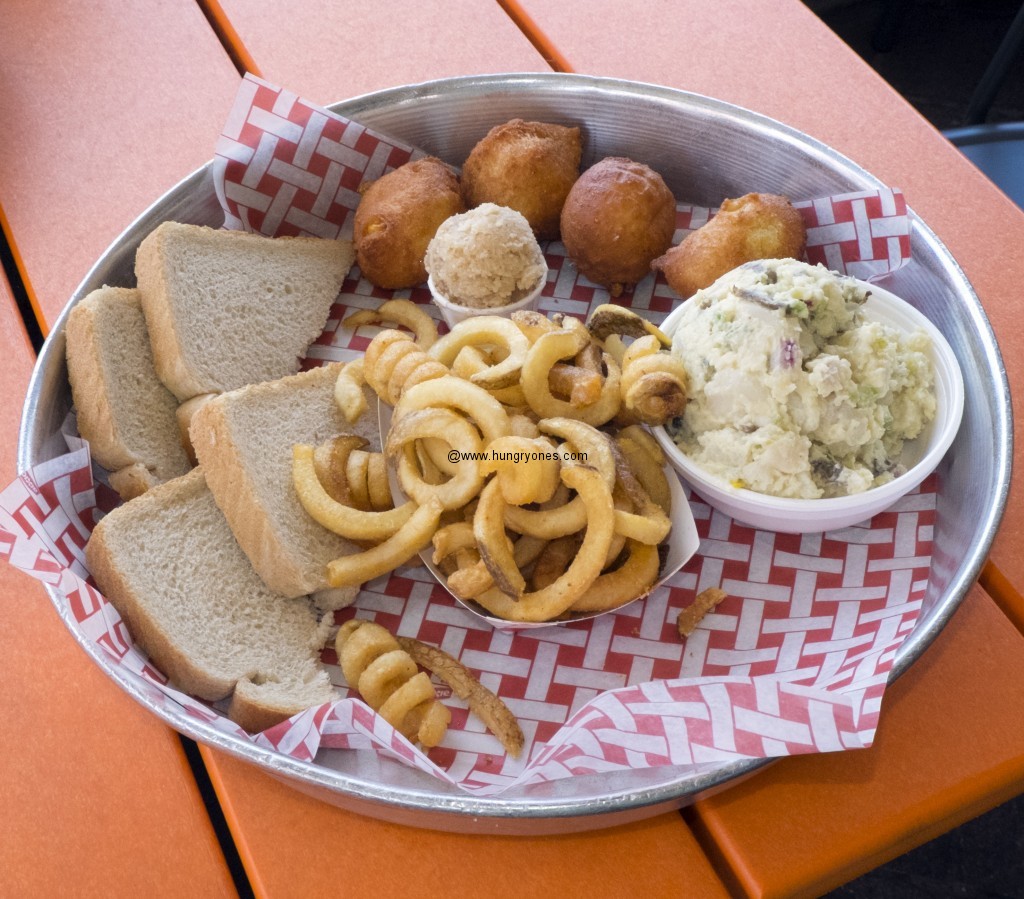 Curly fries, corn fritters, and bread.
