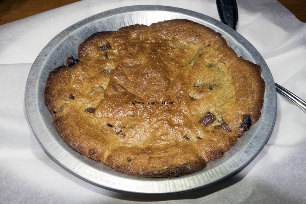 Chocolate chip cookie before the addition of vanilla ice cream.